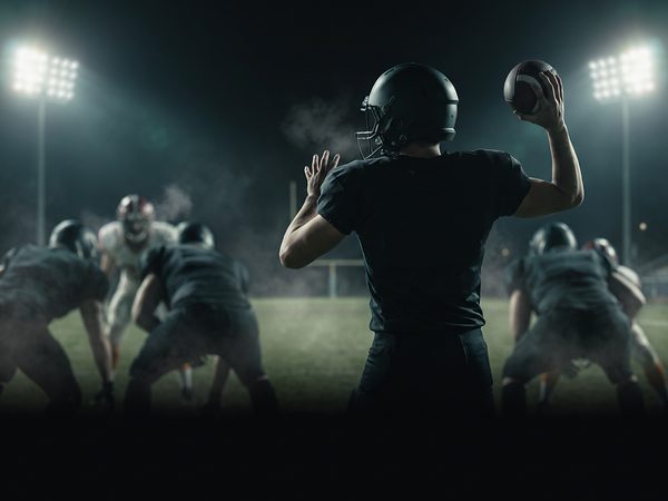 Quarterback preparing to throw under stadium lights